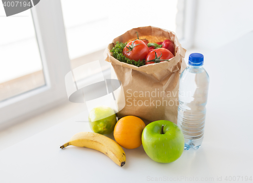 Image of basket of vegetable food and water at kitchen