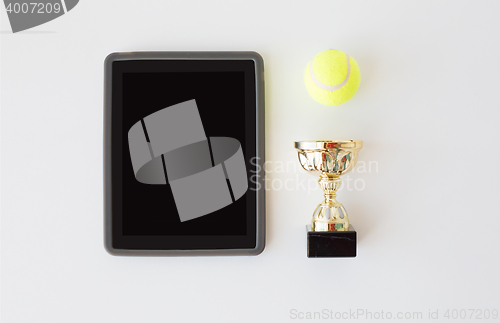 Image of close up of tennis ball, cup and tablet pc
