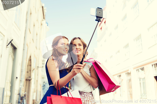 Image of women shopping and taking selfie by smartphone