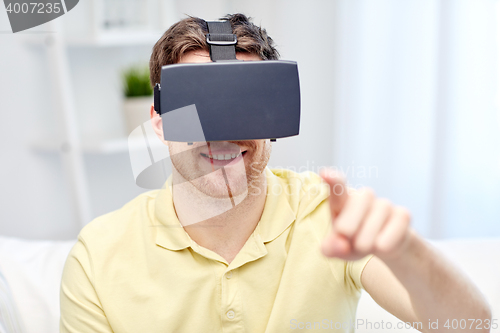 Image of young man in virtual reality headset or 3d glasses