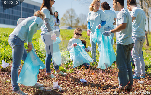 Image of volunteers with garbage bags cleaning park area