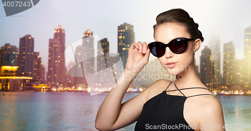 Image of beautiful young woman in elegant black sunglasses