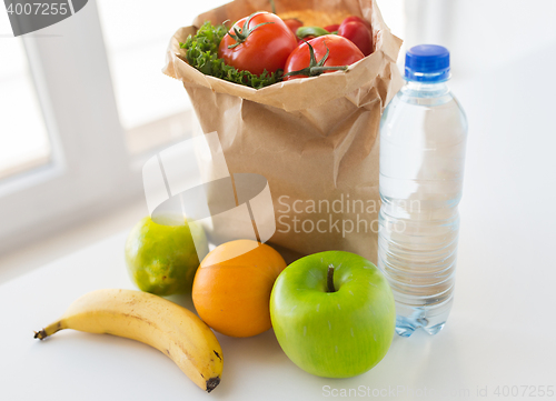 Image of basket of vegetable food and water at kitchen