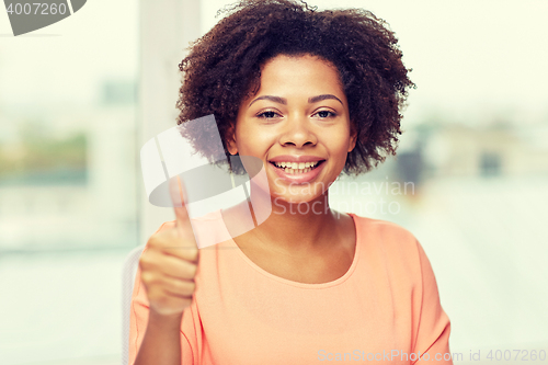 Image of happy african young woman showing thumbs up