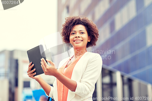 Image of happy african businesswoman with tablet pc in city