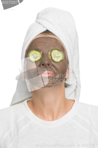 Image of Young beautiful woman in mask for the face. therapeutic black clay. Spa treatment.
