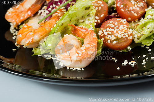 Image of perfect dish with shrimps on a black plate. seafood