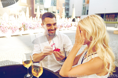 Image of man with engagement ring making proposal to woman