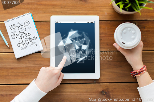 Image of close up of woman with tablet pc on wooden table