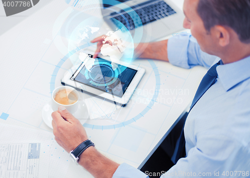 Image of businessman with tablet pc and coffee in office