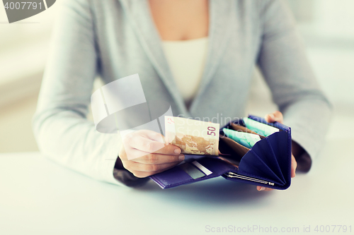 Image of close up of woman hands with wallet and euro money