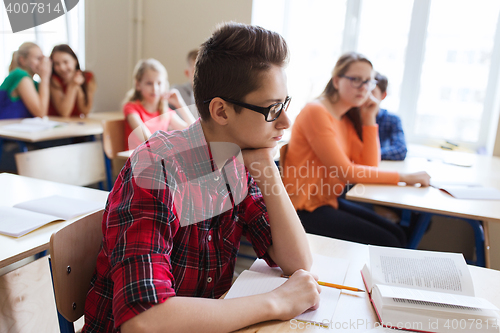 Image of group of students with notebooks at school lesson