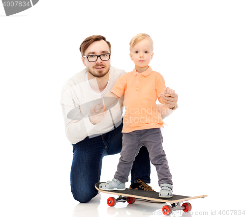 Image of happy father and little son on skateboard