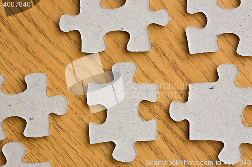 Image of close up of puzzle pieces on wooden surface