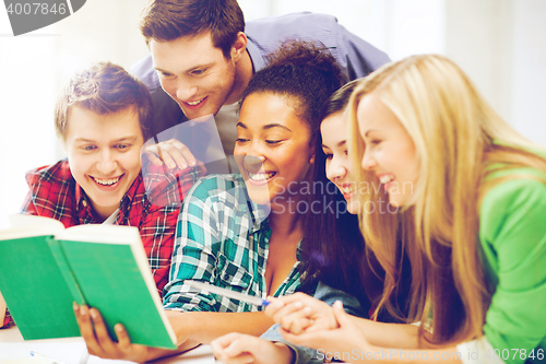 Image of students reading book at school