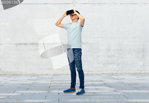 Image of happy man in virtual reality headset or 3d glasses