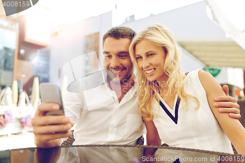 Image of couple taking selfie with smatphone at restaurant