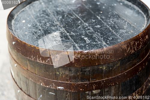 Image of close up of old wooden barrel outdoors