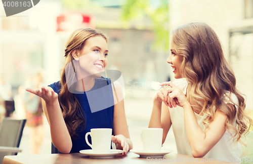 Image of young women drinking coffee and talking at cafe