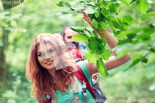 Image of group of smiling friends with backpacks hiking