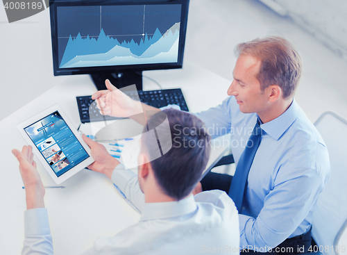 Image of businessmen with tablet pc and computer at office