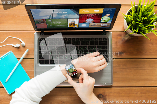 Image of close up of woman with smart watch and laptop