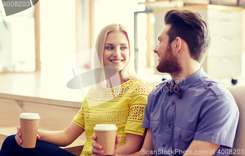 Image of happy man and woman drinking coffee in office