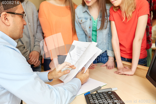 Image of group of students and teacher with tests at school