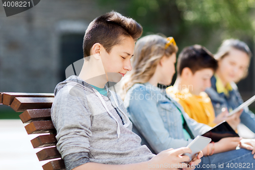 Image of happy teenage boy with tablet pc computer outdoors