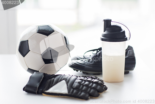 Image of close up of football boots, gloves and bottle