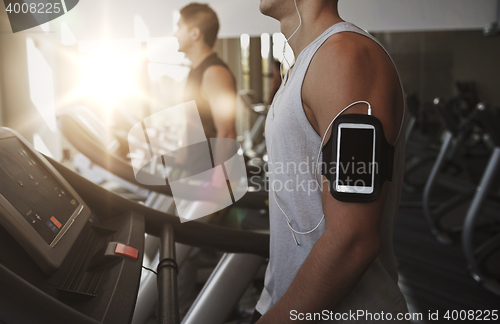 Image of close up of man with smartphone in gym