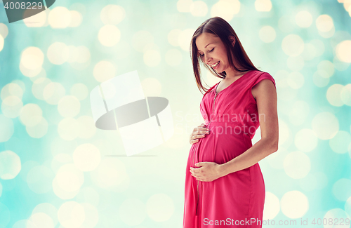 Image of happy pregnant woman with big tummy