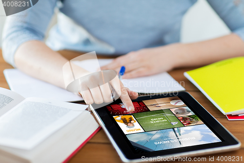 Image of close up of woman with internet news on tablet pc