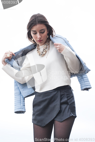 Image of fashionable young model posing with trendy clothes