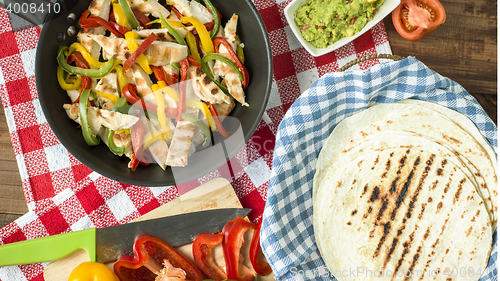 Image of delicious wrap tortilla with spicy chicken vegetables guacamole