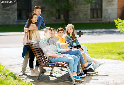 Image of happy teenage students taking selfie by smartphone