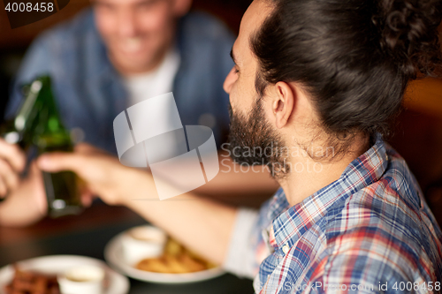 Image of happy male friends drinking beer at bar or pub