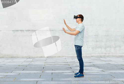 Image of happy man in virtual reality headset or 3d glasses