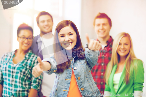 Image of students showing thumbs up at school