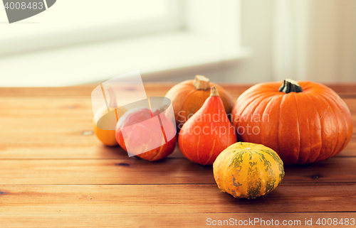 Image of close up of pumpkins on wooden table at home