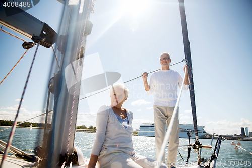 Image of senior couple hugging on sail boat or yacht in sea