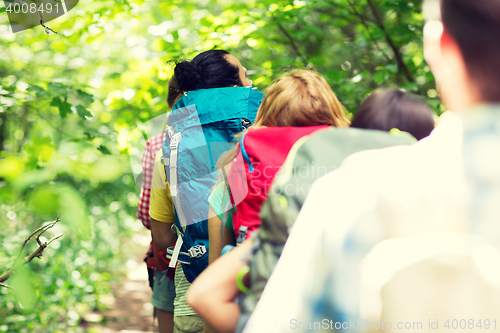 Image of close up of friends with backpacks hiking