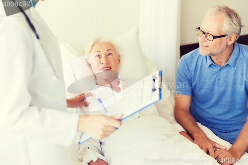 Image of senior woman and doctor with clipboard at hospital