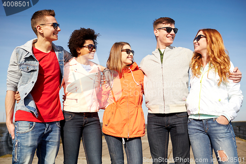 Image of happy teenage friends in shades talking on street