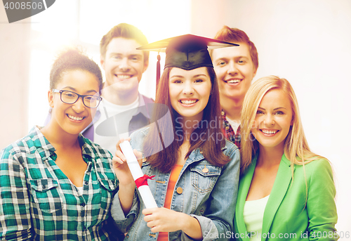 Image of girl in graduation cap with certificate