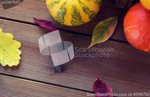 Image of close up of pumpkins on wooden table at home