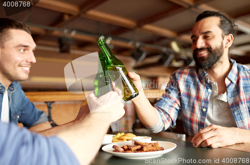 Image of happy male friends drinking beer at bar or pub