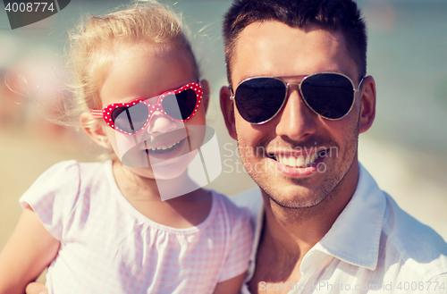 Image of happy family in sunglasses on summer beach