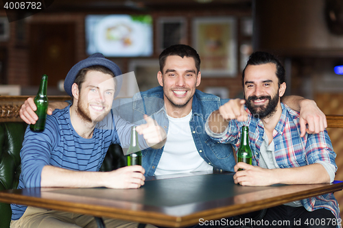 Image of happy male friends drinking beer at bar or pub