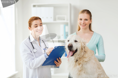 Image of happy doctor with retriever dog at vet clinic